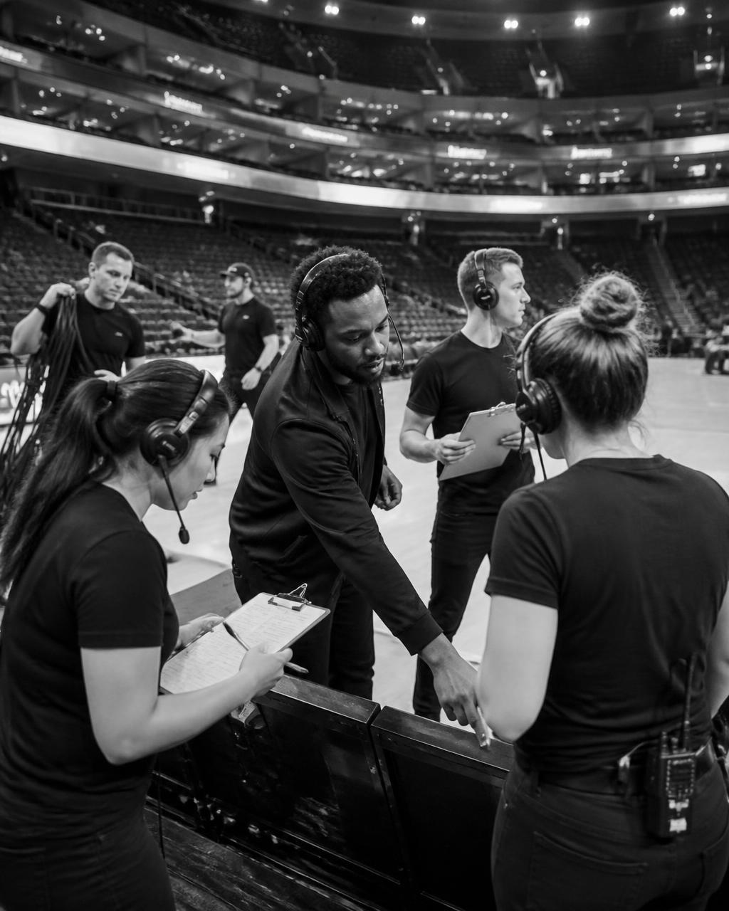 Event operations crew running a run-of-show courtside before a game